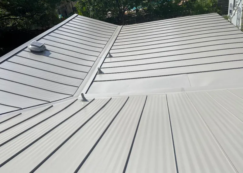 Solar attic fan installed on a metal roof for Roof Ventilation in Mont Belvieu